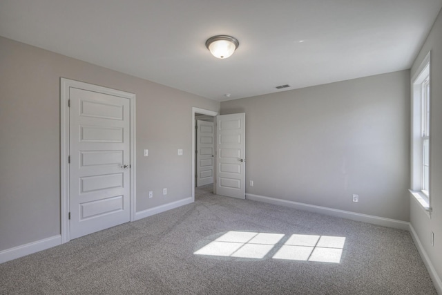 unfurnished bedroom with light carpet