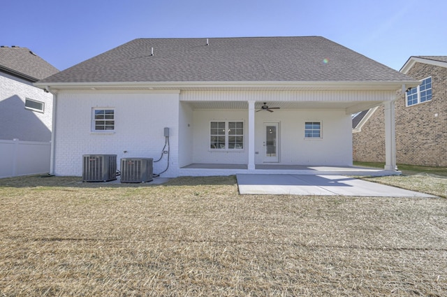 rear view of property featuring cooling unit, ceiling fan, a patio area, and a lawn