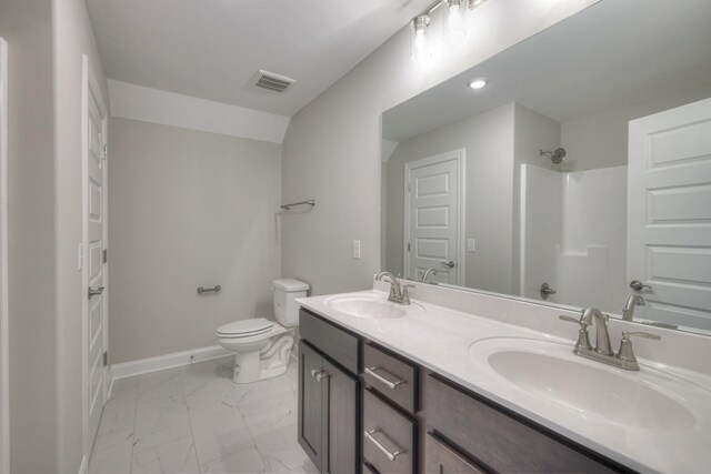 bathroom with walk in shower, vanity, and toilet