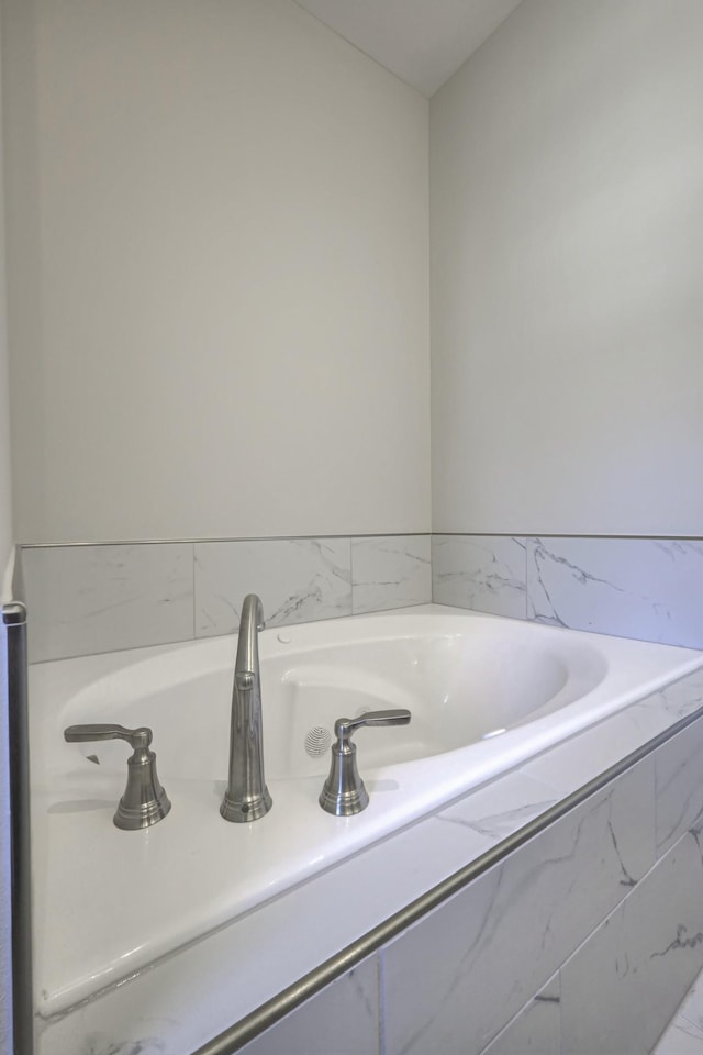 bathroom featuring tiled bath