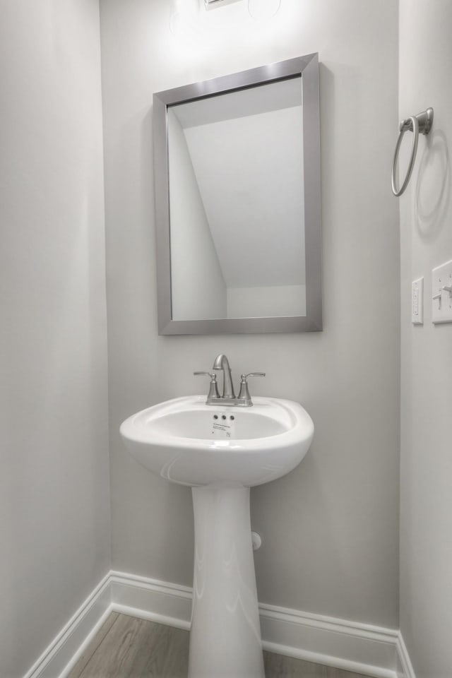 bathroom with hardwood / wood-style flooring