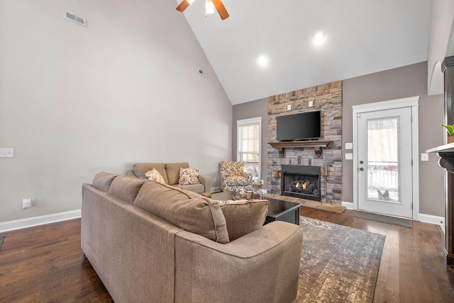 living room featuring dark hardwood / wood-style flooring, plenty of natural light, and a fireplace