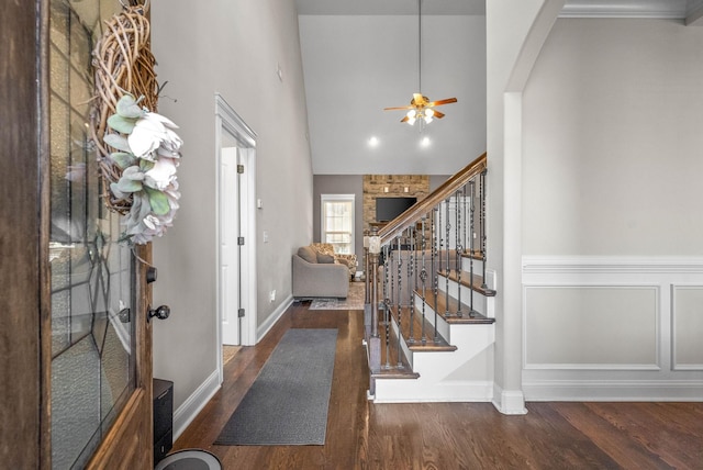 entryway featuring high vaulted ceiling, dark wood-type flooring, and ceiling fan