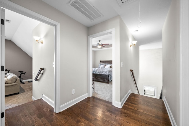 corridor featuring dark hardwood / wood-style floors and vaulted ceiling