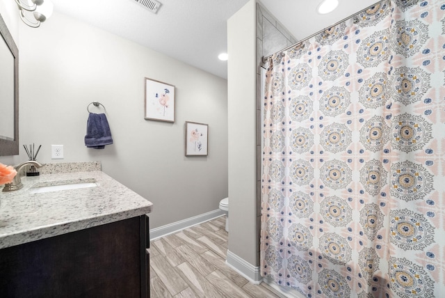 bathroom with vanity, curtained shower, wood-type flooring, and toilet