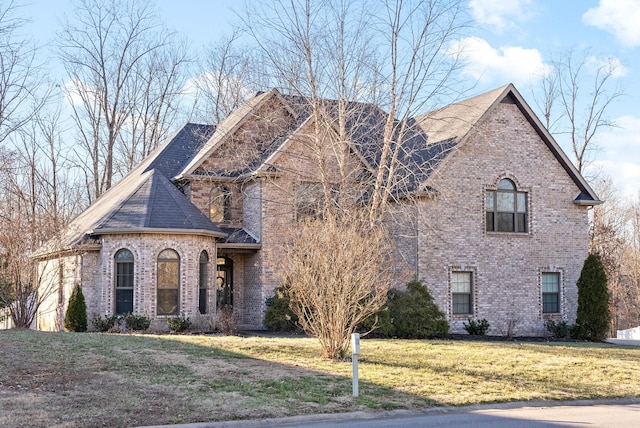 french country inspired facade featuring a front lawn