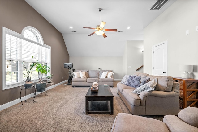 living room featuring lofted ceiling, a wealth of natural light, ceiling fan, and carpet