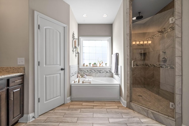 bathroom featuring vanity and separate shower and tub