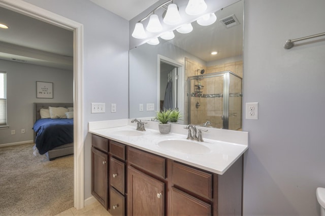 bathroom with vanity and a shower with shower door