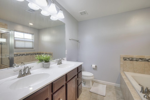 full bathroom featuring tile patterned flooring, vanity, shower with separate bathtub, and toilet