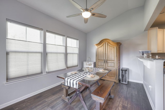 dining area featuring ceiling fan, lofted ceiling, and dark hardwood / wood-style flooring