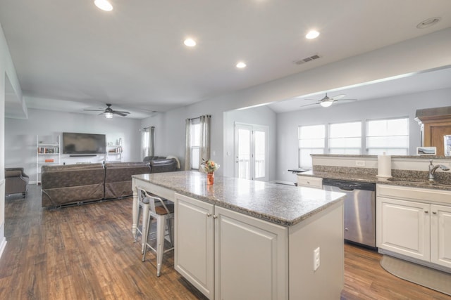 kitchen with white cabinetry, dishwasher, a center island, and sink