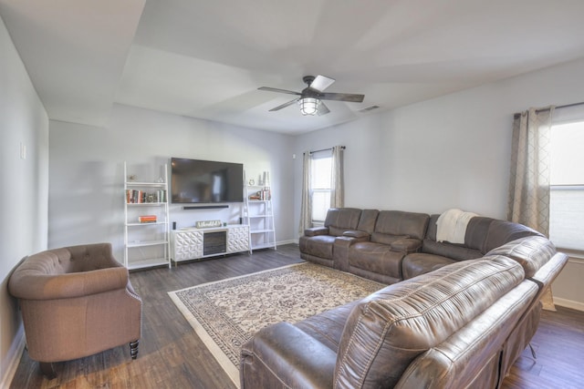 living room with dark wood-type flooring and ceiling fan