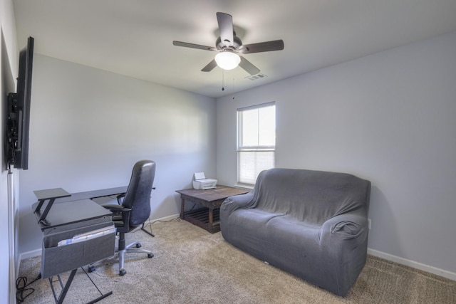 office space featuring light carpet and ceiling fan