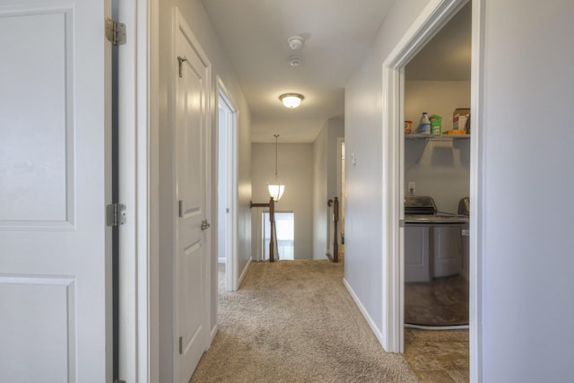 hall featuring washer and dryer and light carpet