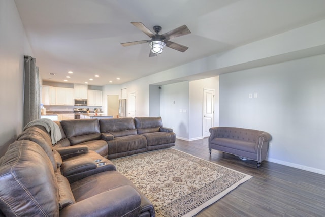 living room with ceiling fan and dark hardwood / wood-style flooring