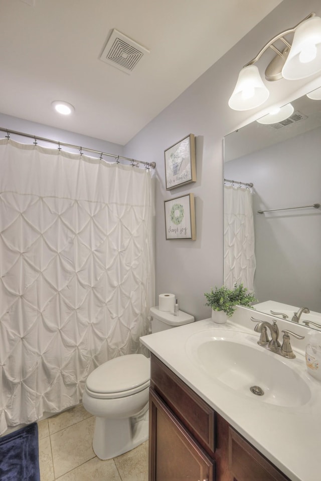 bathroom with a shower with curtain, vanity, toilet, and tile patterned flooring