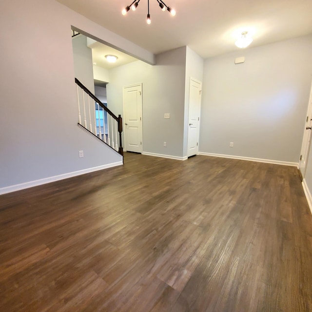 unfurnished living room with dark hardwood / wood-style flooring