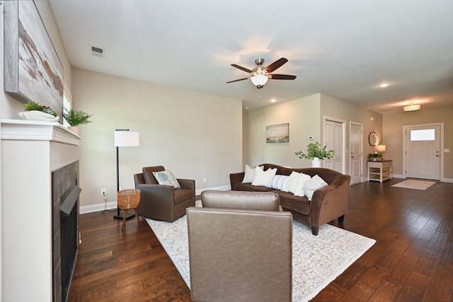 living room featuring dark hardwood / wood-style flooring and ceiling fan