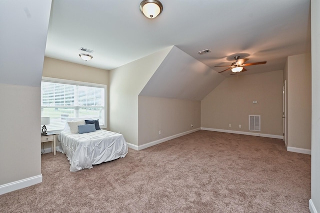 carpeted bedroom featuring vaulted ceiling and ceiling fan