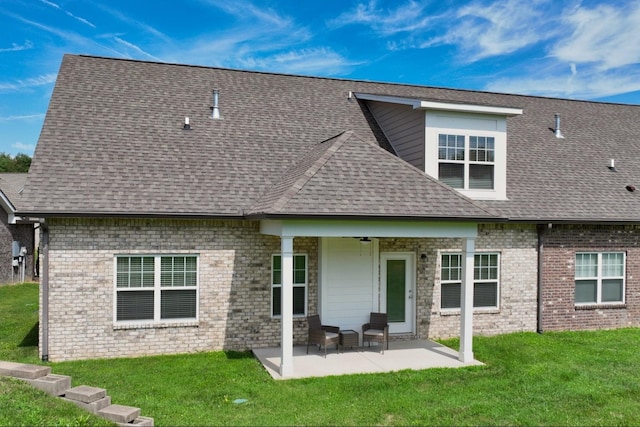 back of house with a yard and a patio