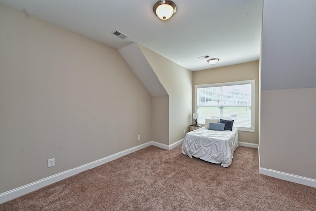 unfurnished bedroom featuring lofted ceiling and carpet flooring