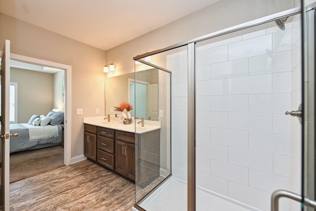 bathroom featuring vanity, hardwood / wood-style floors, and an enclosed shower