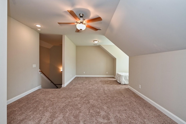 bonus room with ceiling fan, lofted ceiling, and light carpet