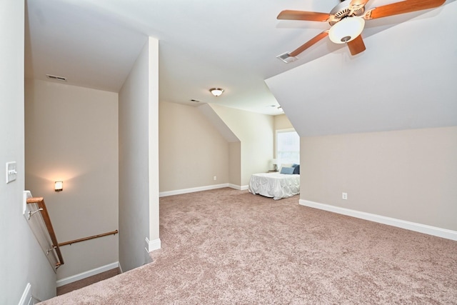 additional living space featuring light carpet, vaulted ceiling, and ceiling fan