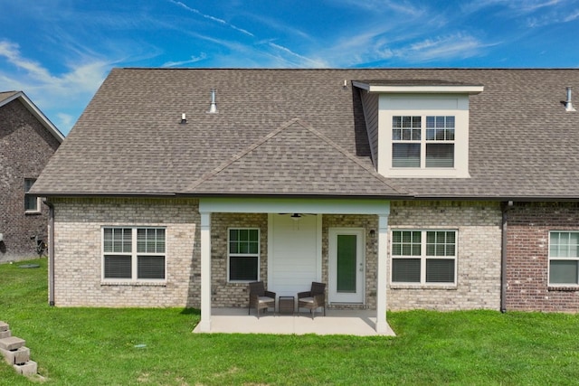 back of house with a patio area and a lawn