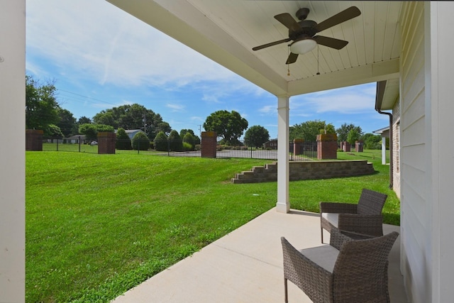 view of yard with ceiling fan and a patio area