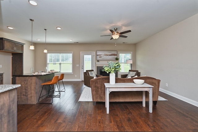 dining area with dark wood-type flooring, ceiling fan, and plenty of natural light