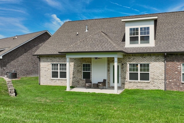 rear view of property featuring a patio, central AC unit, ceiling fan, and a lawn