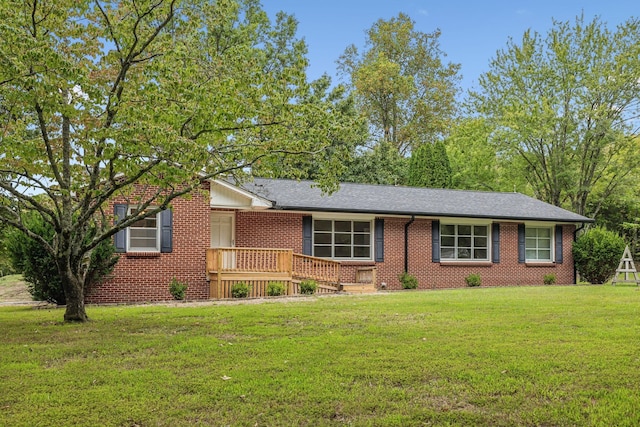 ranch-style house with a wooden deck and a front yard