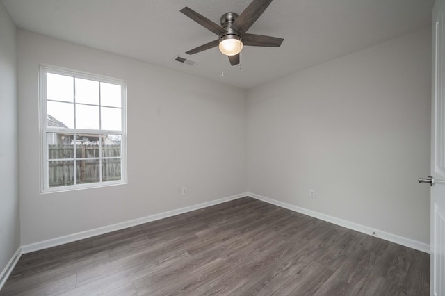 unfurnished room featuring dark hardwood / wood-style floors and ceiling fan