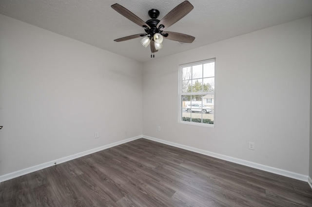 empty room featuring ceiling fan, dark hardwood / wood-style flooring, and a textured ceiling