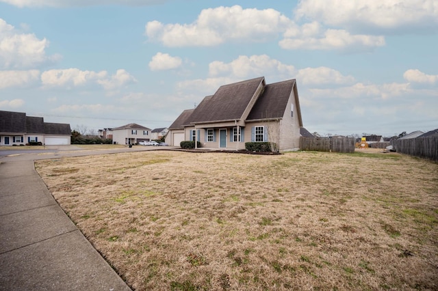 exterior space featuring a garage and a front yard