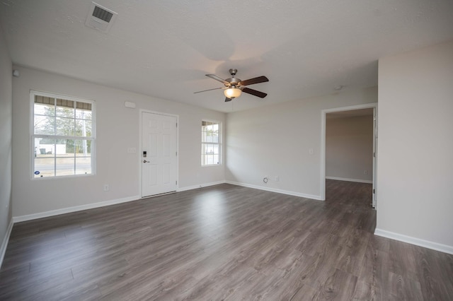 spare room with ceiling fan, dark hardwood / wood-style floors, and a textured ceiling