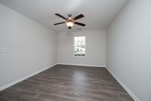 spare room featuring ceiling fan, a textured ceiling, and dark hardwood / wood-style flooring