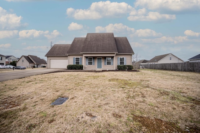 view of front of property with a garage and a front lawn