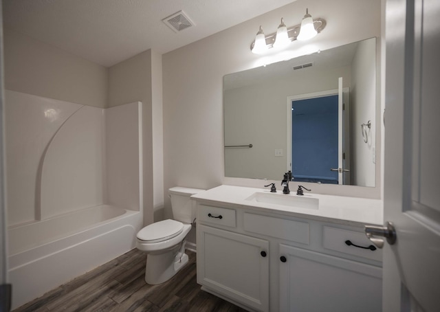 full bathroom with vanity, wood-type flooring, shower / washtub combination, and toilet