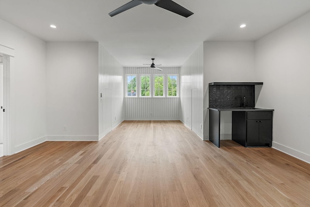 unfurnished living room with light hardwood / wood-style flooring and ceiling fan