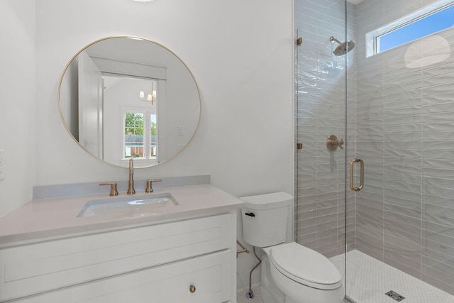 bathroom with walk in shower, vanity, and toilet