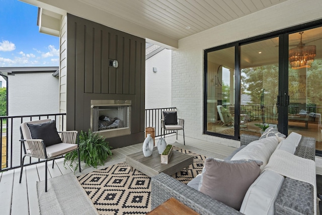 balcony with an outdoor living space with a fireplace