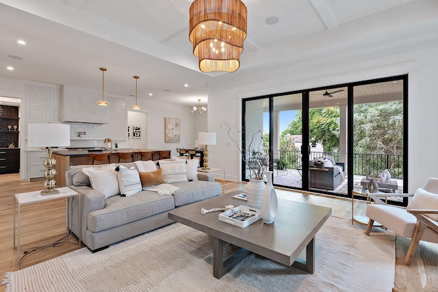 living room with a chandelier and light hardwood / wood-style floors