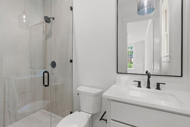 bathroom featuring vanity, an enclosed shower, and toilet