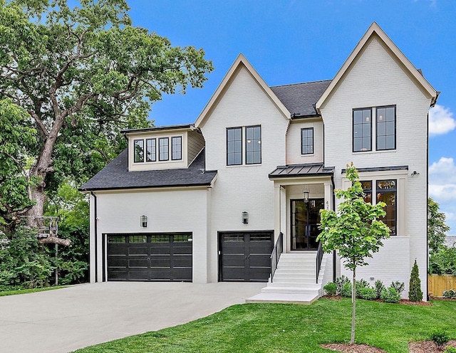 modern inspired farmhouse featuring a garage and a front yard