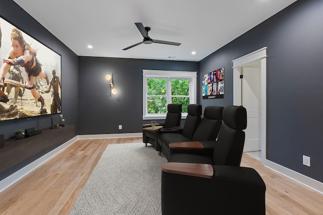 home theater featuring ceiling fan and light hardwood / wood-style floors