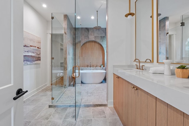 bathroom featuring vanity and separate shower and tub