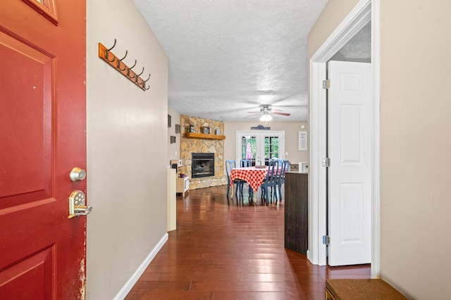 hallway featuring dark wood-type flooring and a textured ceiling